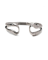 Chunky hammered stainless steel bangle bracelet with an open design and unique twisted ends, suitable for stacking.