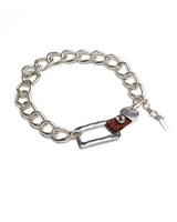 Chunky silver chain bracelet featuring a brown leather belt buckle detail. Adjustable fit with a trendy punk-chic design.