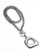 Silver chain necklace with a unique pendant on a white background