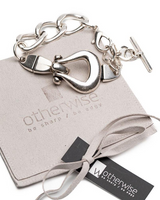 Silver bracelet with decorative clasp on a 'otherwise' branded box.