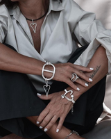 Silver heart necklace set featuring a black leather necklace with a silver heart and two adjustable chunky bracelets.