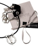 Bold black leather and shiny silver oversized shackle necklace, bracelet, and adjustable ring set, presented on a suede pouch.