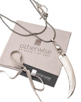 Necklace with a large white pendant on a 'otherwise' branded card.