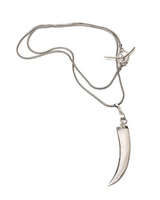 A silver-toned metal necklace featuring a curved, tooth-like pendant on a delicate snake chain, displayed against a solid white background.