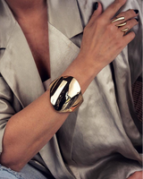 Honey Gold Geometric Cuff bracelet worn on a model’s wrist, featuring a bold, shiny gold geometric design.