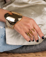 Honey Gold Geometric Cuff bracelet featured on a model's wrist, showcasing its shiny gold finish and bold, geometric design.