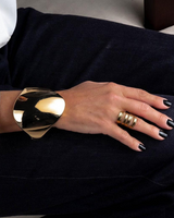 Honey Gold Geometric Cuff bracelet displayed on a model's wrist, featuring a bold gold geometric design and a shiny finish.