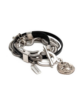 Multistrand bracelet with metal clasp and pendant on a white background