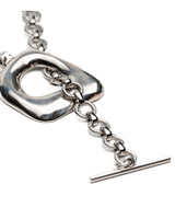 Chunky silver statement necklace and bracelet set features oversized organic links and intricate chain details.
