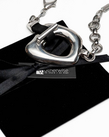 Chunky silver statement necklace and bracelet set with organic metal links, displayed on a black suede pouch with a tag.