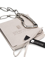 Silver chain necklace on a branded card with 'otherwise' logo.