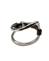 Metallic ring with a brown band on a white background