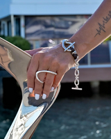 Sterling silver plated adjustable two-finger ring with a unique geometric design, worn on a hand with white nails.