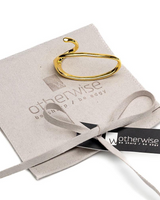 Adjustable gold two-finger ring with a unique geometric design, displayed on a suede gift pouch with branding.