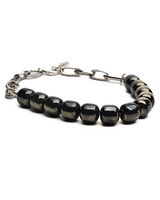Layered choker set featuring gunmetal tubes and dark semi-precious gemstone beads, showcasing a sleek and edgy design.