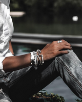 Zamak Metal Leather Cuff Bracelet with an edgy design, featuring a mix of metallic leather and silver accents stacked on a wrist.