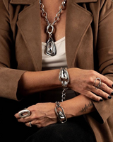 Swarovski crystal necklace and bracelet set worn by a model, featuring silver-plated metal and bold crystal accents.