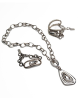 Swarovski crystal necklace and bracelet set featuring silver-plated metal accents, showcasing a bold, artisanal design.