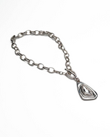Chunky silver-plated necklace featuring a bold, teardrop-shaped Swarovski crystal pendant with intertwined links.