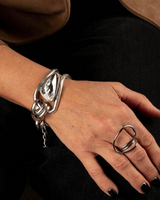 Chunky silver-plated bracelet featuring a large Swarovski crystal, paired with an adjustable silver ring.