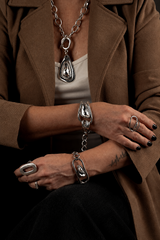 Swarovski crystal necklace and bracelet set featuring silver-plated metal with chunky linked designs, worn by a model.