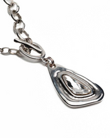 Chunky silver-plated necklace featuring a teardrop Swarovski crystal pendant, set on a modern link chain.