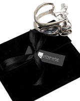 Swarovski crystal and silver-plated metal bracelet featuring a large crystal, displayed on a black suede pouch.