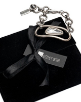 Swarovski crystal necklace and bracelet set featuring clear crystals and silver-plated metal, presented in a black suede pouch.