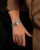 Swarovski crystal bracelet with bold silver links, worn with a coordinating chunky silver ring on a model's hand.