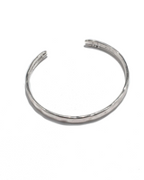 Silver-plated hammered bangle cuff with an adjustable design, ideal for stacking with other bracelets.