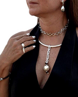 Woman wearing a necklace, earrings, and bracelet on a white background