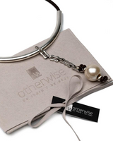 Bracelet with pearl charm on a branded card with 'otherwise' logo
