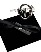 Bold black leather cuff with a hand-sculpted horsebit centerpiece, presented in a black suede gift pouch.