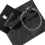 Elegant 999 silver antique plated anklet with round charms, displayed with a black suede pouch and ribbon.