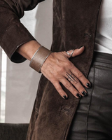 Person wearing a brown coat with a blurred background