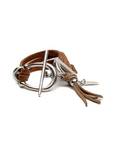 Brown leather bracelet with silver clasp and tassel on a white background