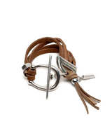 Brown leather bracelet with silver clasp and tassel on a white background