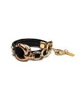 Black leather bracelet with gold chain and clasp on a white background