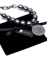 Layered necklace set featuring dark semi-precious beads and stainless steel chains, with a round pendant charm.