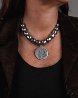 Layered necklace set featuring dark polished semi-precious gemstones and stainless steel chain links, worn on a model.