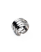 Adjustable silver-plated geometric ring with asymmetric lines, featuring a unique layered design for versatile wear.