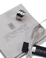 Adjustable silver-plated copper ring with a unique geometric design, presented on a soft suede pouch.