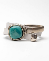 Silver ring with a turquoise stone on a white background