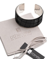 Black and silver cuff bracelet on a branded box with 'otherwise' tag.