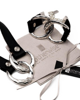 Chunky leather link set featuring black leather straps and hammered sterling silver plated links, presented on a suede pouch.