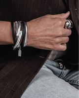Black leather wrap bracelet featuring natural black leather and rhodium-plated snake chain, wrapped twice around the wrist.
