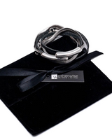 Black leather wrap bracelet featuring a silver-plated snake chain, wrapped twice with a magnetic closure, resting on a black pouch.
