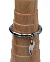 Silver bracelet with a leaf-shaped charm on a wooden stick