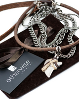 Necklace with a pendant on a brown velvet surface, accompanied by an Otherwise Jewelry card.