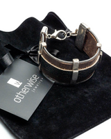 Bracelet on a black velvet cushion with 'otherwise' brand tag